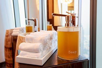Liquid soap and towels in a hotel bathroom